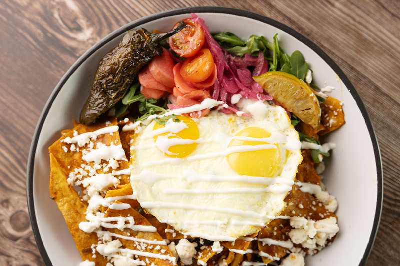 Chilaquiles Plate at Brekki Brekki - A vibrant plate of chilaquiles served at Brekki Brekki, located on Comanche Road Northeast in Albuquerque, NM. Perfect for anyone searching for the best breakfast in Albuquerque or restaurants near me.